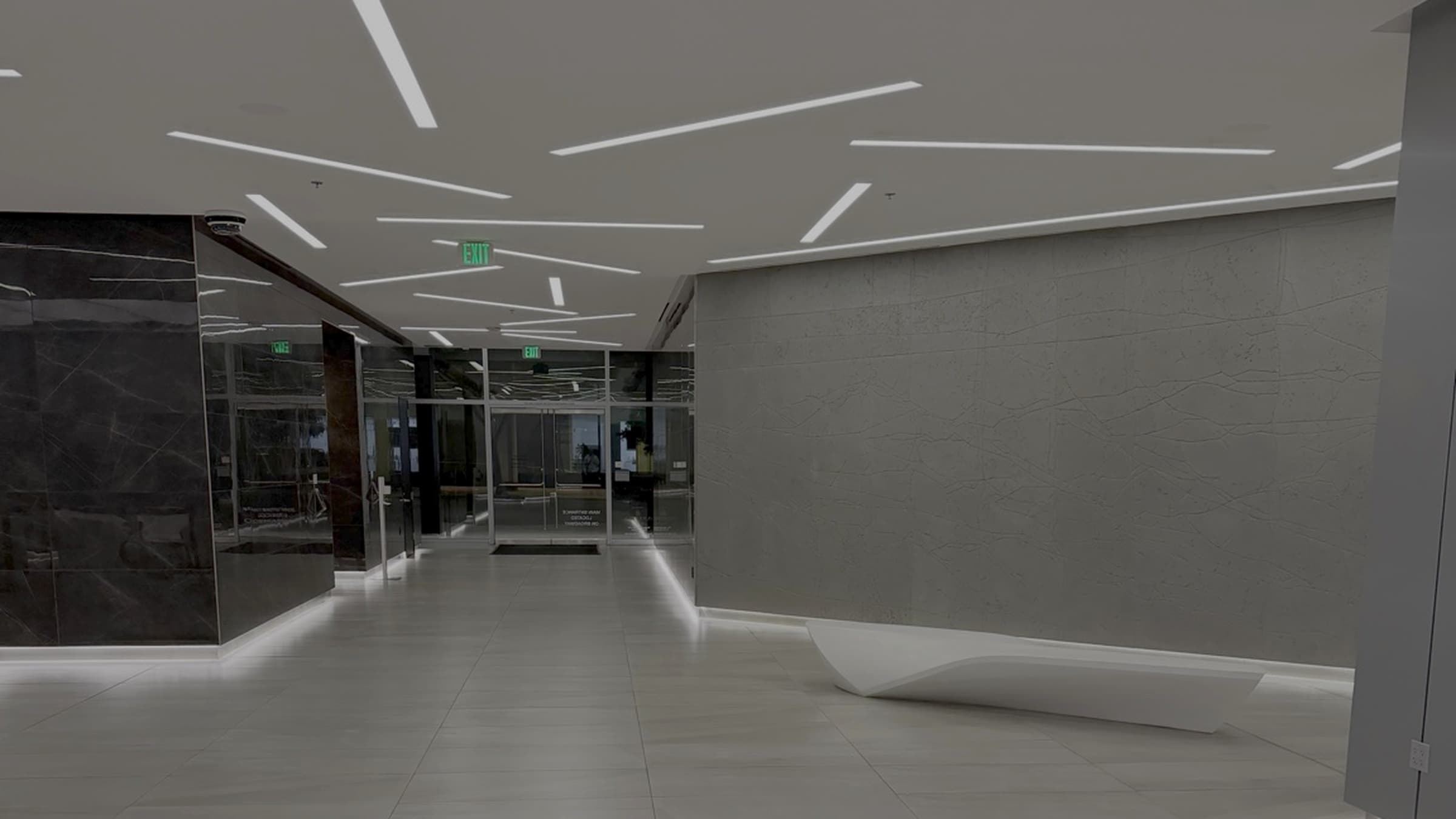 Modern corporate office lobby with glass walls and clean tiled floors